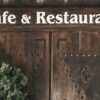 Wooden entrance of a cafe and restaurant in Amasya with rustic signage.