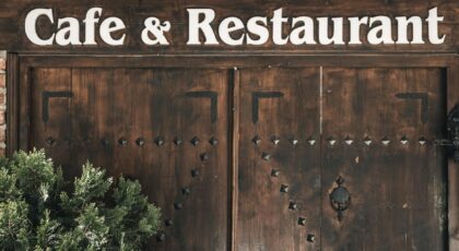 Wooden entrance of a cafe and restaurant in Amasya with rustic signage.
