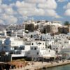 Stunning view of traditional white architecture in Naxos, Greece under a vibrant sky.