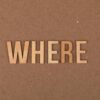 Wooden letters spelling 'WHERE' on a brown cardboard background.