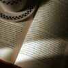 An open book with a coffee cup, capturing a serene reading atmosphere indoors.
