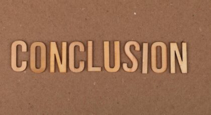 Wooden letters arranged to spell 'Conclusion' on a brown cardboard background.