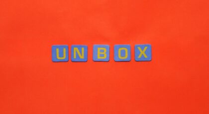 Bright letters spelling 'unbox' on a vivid red background, minimalist design.