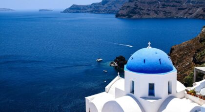 Experience the breathtaking beauty of Santorini's iconic blue-domed churches overlooking the Aegean Sea.
