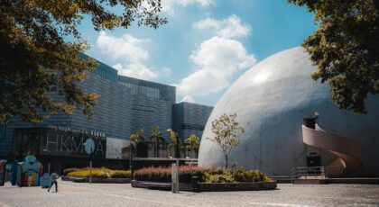 Photo of Hong Kong Space Museum dome and Hong Kong Museum of Art under a sunny sky.