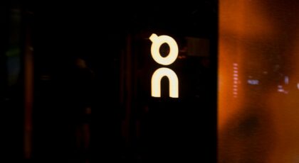 Stylish neon sign with a reflective glow in a dark setting, creating a modern and minimalist ambiance.