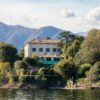 Picturesque villa on the shores of Lake Como surrounded by lush greenery and mountain views.