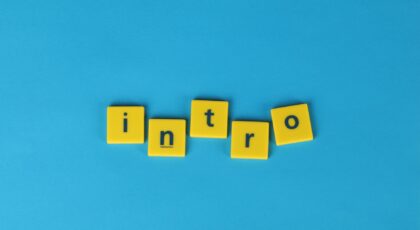 Yellow letter tiles spell 'intro' on a vibrant blue background, ideal for creative projects.