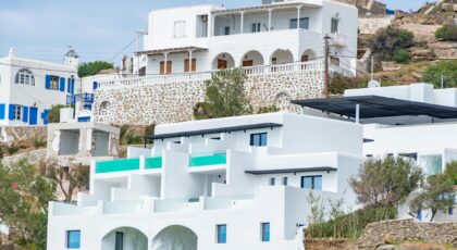 Whitewashed buildings on a Greek island showcasing traditional architecture with sea views.
