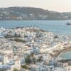 Aerial view of Mykonos Old Port in Greece showcasing traditional white buildings and the Aegean Sea.