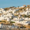 Scenic view of traditional white homes on a Greek island during daytime.