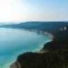 Discover the breathtaking aerial view of a tranquil lake surrounded by lush hills in Texas, showcasing nature's beauty.