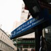 Urban street sign pointing to Central Mid-Levels Escalator in Hong Kong.