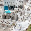 Explore the stunning white-washed buildings of Santorini with this captivating aerial view.